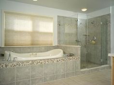 a bathroom with a large tub and walk in shower