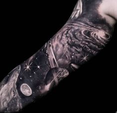 a man with a tattoo on his arm that has an image of the earth and stars