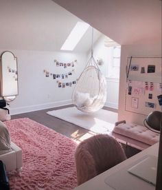 a bedroom with pink carpet and hanging chair