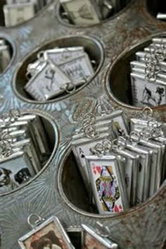 a metal tray filled with lots of different types of playing cards and pictures on it