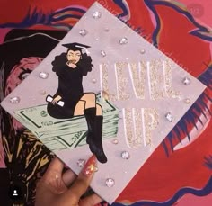 someone holding up a graduation cap with the words level up on it and an image of a woman's legs