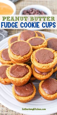 peanut butter fudge cookie cups on a white plate with chocolate chips in the background