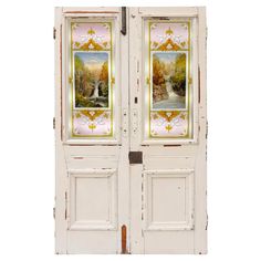 two white doors with paintings on them