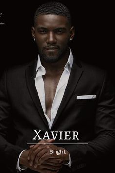 a man in a black suit and white shirt is holding his hands together with the words xavier on it