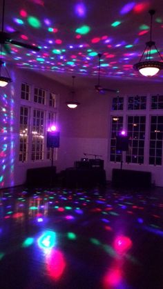 an empty room with disco lights on the ceiling