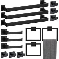 black bathroom accessories including towel rack, toilet paper holder and towels