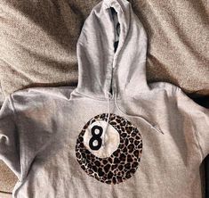 Handmade Patchwork Cheetah Print 8 Ball Hoodie. Please read the full product description below before ordering! Model is wearing a size s  ⋆ ˚｡ ⋆୨♡୧⋆ ˚｡ ⋆ Join our instagram @rainy.swagg & tag us in your pics! ♡ ✩ QUALITY & SUSTAINABILITY ✩ *100% cotton hoodie, hand sewn by me!  * Every one of our hoodie is made to order to reduce waste. * Our hoodies are original designs, created with love ✩ SHIPPING TIMES ✩ United States ONLY!  standard shipping 3-7 days  express shipping 2-3 days  (does take How Lucky Are We Sweatshirt Diy, How Lucky Are We Hoodie Diy, 8 Ball Sweatshirt, Dream Clothes Y2k, Easy Cute Sewing Ideas, Hoodie Made From Quilt, Black Embroidered Sweatshirt, Hoddies Idea, Iron On Letters Shirt Diy Ideas