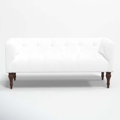 a white couch sitting on top of a wooden floor