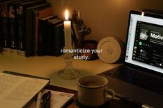 an open laptop computer sitting on top of a desk next to a cup of coffee