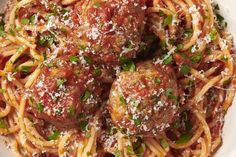 spaghetti with meatballs and parmesan cheese on top