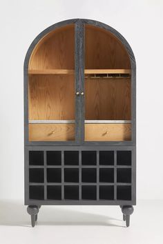 a wooden cabinet with two glass doors on the front and bottom shelves in different sizes