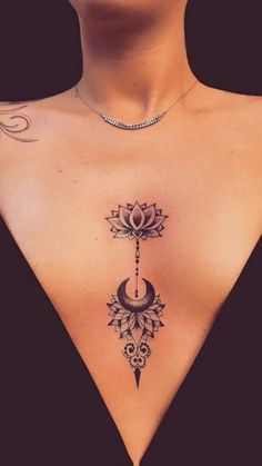 the back of a woman's neck with a cross and lotus tattoo on it