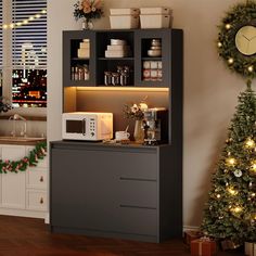 a kitchen with a microwave and christmas decorations