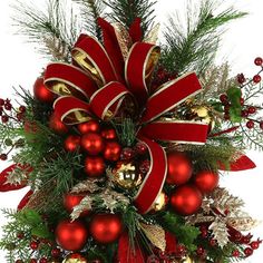 a christmas tree decorated with red and gold baubes, ornaments and greenery