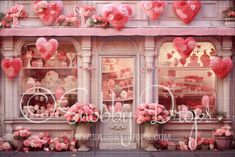 a store front with pink flowers and hearts hanging from the windows