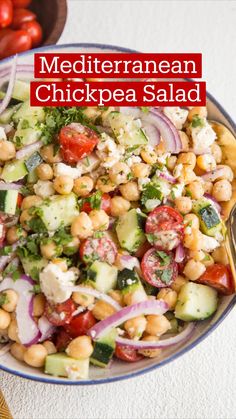 a salad with chickpeas, cucumber, tomatoes and onions in a bowl