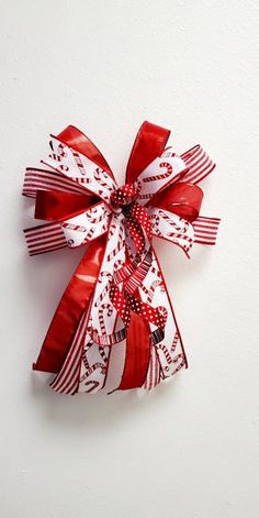 a red and white bow on a white wall