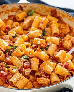 a skillet filled with pasta and meat