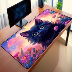 a computer desk with a cat mouse pad on it