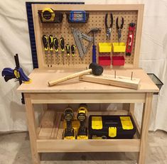 a workbench with tools and hammers on it, ready to be assembled