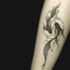 a black and white photo of a mermaid tattoo