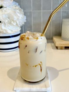 there is a drink with ice cream and gold spoon in it