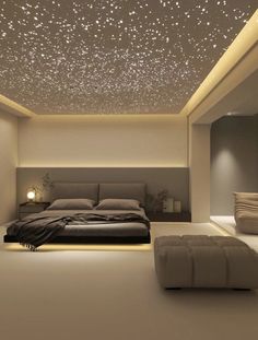 a large bed sitting under a ceiling covered in stars