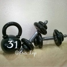 a pair of black dumbbells sitting on top of each other with the number 31 printed on them