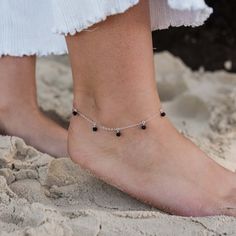 The perfect example of bohemian, free-spirited style - say hello the black lava rock bead drop anklet! Delicately pretty, this stunning anklet is hand crafted using the traditional technique of wire wrapping to drop the semi-precious gemstones from the chain. It makes the ideal present for adventurers, wanderers and wild freedom-seekers. Silver Anklet With Black Beads, Anklet Designs Beads, Black Beads Anklets, Anklets Aesthetic, Anklet Aesthetic, Designer Anklets, Delicate Anklets