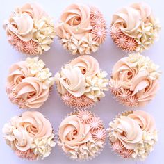 twelve cupcakes with pink frosting and white flowers on them are arranged in rows