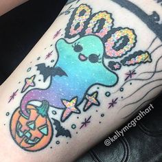 a person with a tattoo on their leg that has an octopus and pumpkins on it