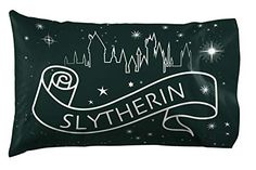 a black and white pillow with the name slytherin on it in front of a night sky filled with stars