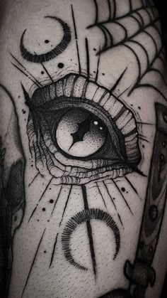 a tattoo with an all seeing eye on it's arm and some scissors in front of it