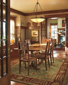 a dining room table with chairs and rug on the floor