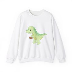 Cozy T-rex and Dino reading sweater perfect for the colder months. Gives off a cozy and whimsical vibe, ideal for those who love dinosaurs and reading. Great for casual wear and lounging around the house during the holiday season. Product features - Ethically sourced cotton blend fabric - Classic fit with crew neckline for comfort - Durable double-needle stitching - Itch-free tear-away label - OEKO-TEX-certified dyes with low environmental impact Care instructions - Machine wash: cold (max 30C o Winter Top, Top Funny, Winter Tops, Book Lover, T Rex, Crewneck Sweatshirt, Sweat Shirt, Gender Neutral, Casual Wear