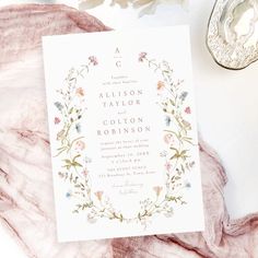 the wedding stationery is laid out on a table