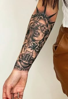 a woman's arm with a statue of liberty tattoo on it