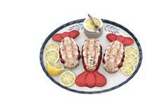 an image of lobsters on a plate with lemon wedges and ketchup