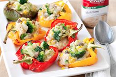 several stuffed peppers with broccoli and cheese on them