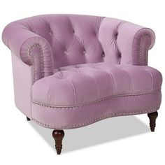 an upholstered purple chair with studding on the armrests and back