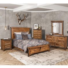 a bedroom with a bed, dresser and mirror on the wall next to an antelope headboard