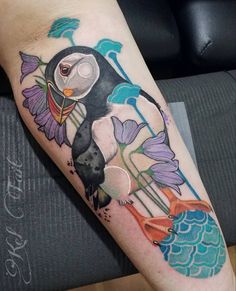 a penguin with flowers on his leg