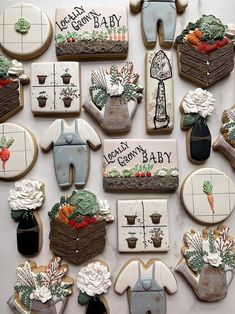 decorated cookies are arranged in the shape of baby's first birthdays and other items