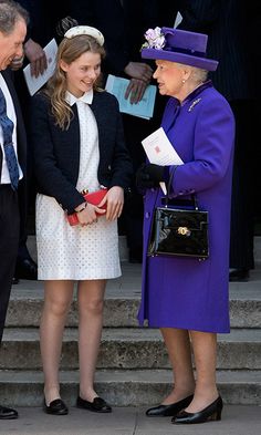 the queen and prince are greeting each other