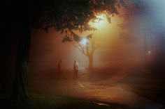 two people standing in the fog at night