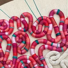 some pink and red yarn on a table