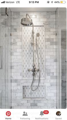 an instagramted photo of a shower with white tile and gray grouting