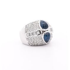 18KW ~4.00 Carat Cabochon Sapphire and Diamond Ring – DP-~0.90ct (8pc), DR-~1.20ct; 16.39g size 6  This captivating ring features a stunning 4-carat blue sapphire, showcased in a sleek bezel setting crafted from 18k white gold. The cabochon cut of the sapphire accentuates its natural beauty, while sparkling princess and round cut diamonds on both sides add a touch of elegance. The ring is available in size  US 6 and weighs 16.39 grams.   Details:  ✔ Item Type: Ring  ✔ Metal: 18k White Gold  ✔ Si Vintage Solitaire Engagement Ring, Wide Band Engagement Ring, Filigree Diamond Ring, 18k Gold Ring, Sapphire Diamond Ring, Gold Band Ring, Minimalist Rings, Sapphire Diamond, Topaz Ring