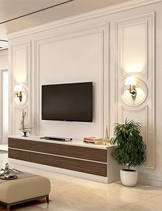 an elegant living room with white walls and beige furniture, large flat screen tv on the wall