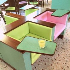 an empty restaurant with colorful booths and tables